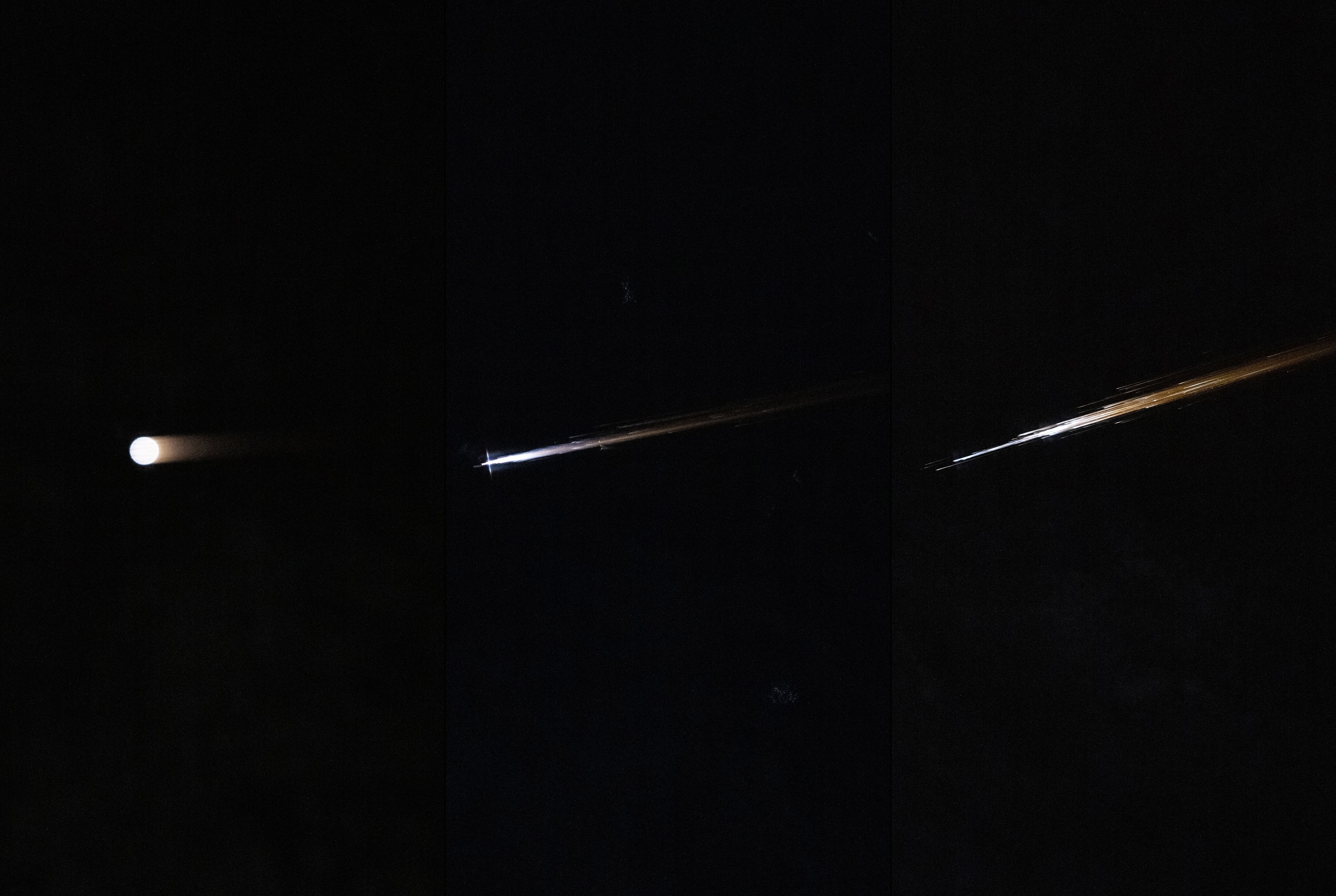 Three separate bright lights flare on dark background as a piece of space junk breaks up in Earth's atmosphere Three separate bright lights flare on dark background as a piece of space junk breaks up in Earth's atmosphere